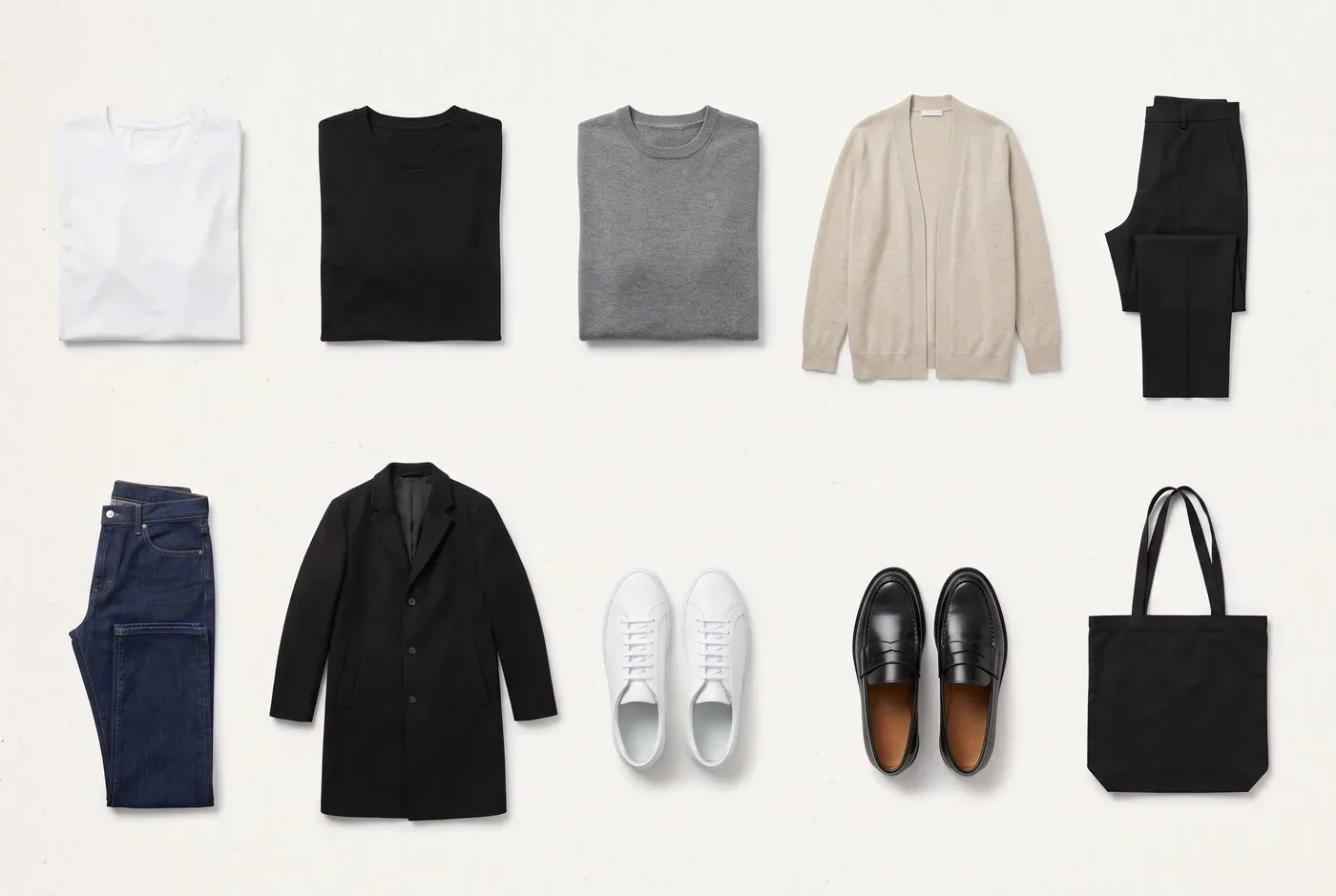 Flat lay grid of a ten-piece capsule wardrobe in black, white, grey and oatmeal, including T-shirts, knits, trousers, jeans, a coat, sneakers, loafers and a tote